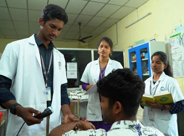 Physiotherapy laboratory with students following lab safety guidelines and hands-on clinical practice at Cheran College of Physiotherapy, Coimbatore.
